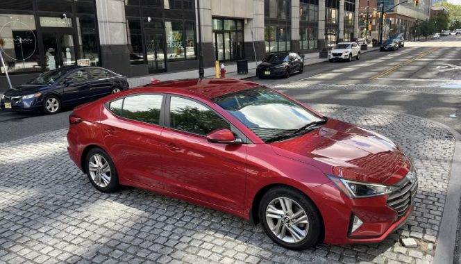 Red Hyundai Elantra parked on a Jersey City street